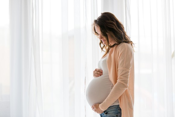 Pregnant woman holding her stomach