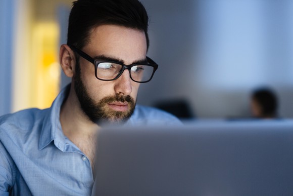 Man at a laptop, looking concerned