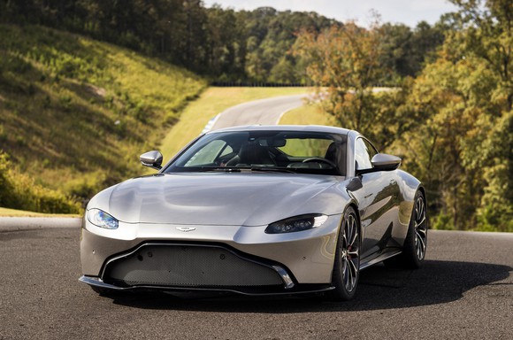 A silver Aston Martin V8 Vantage, a two-seat sports car with sleek, aggressive styling.