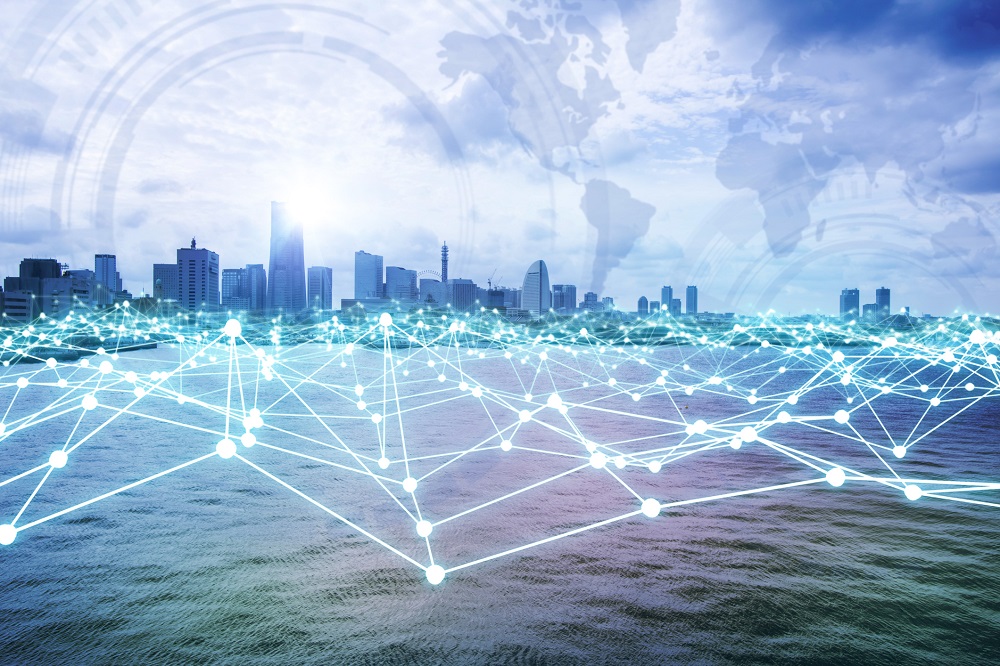 A view of a city skyline from the water, with a digital network overlaid on top.