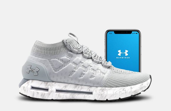 Under Armour's HOVR Phantom shoe shown on a white background with the MapMyRun App shown on a phone behind it.