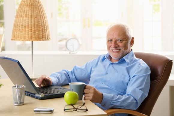 Smiling older man at desk