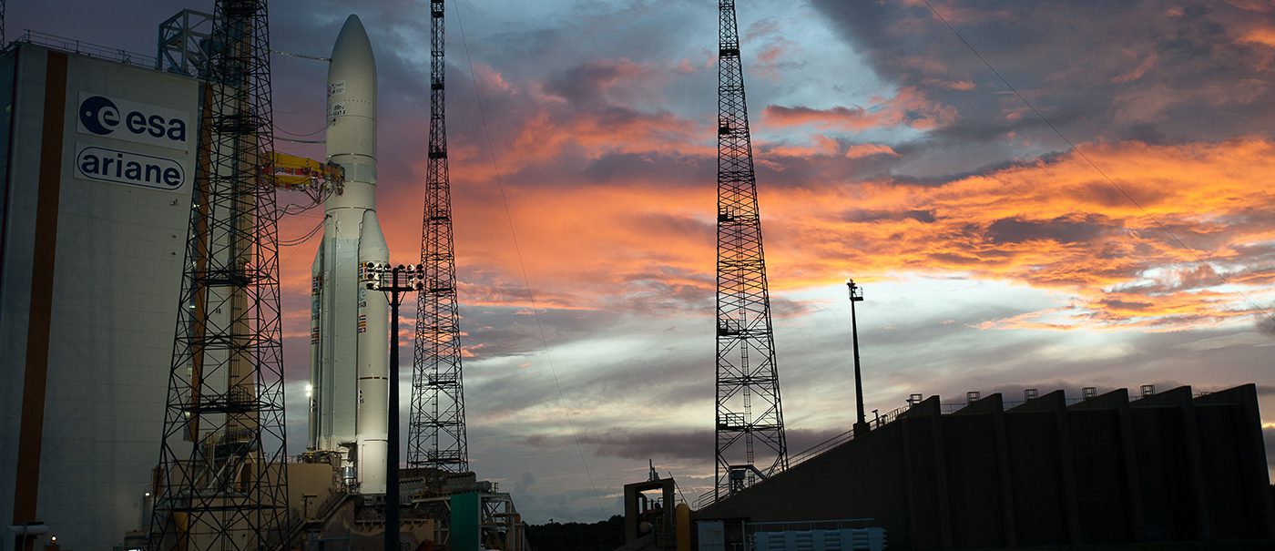 Ariane rocket on pad at sunset