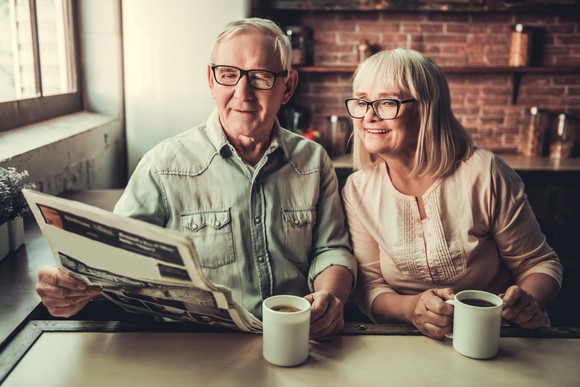 Senior couple reading a newspaper