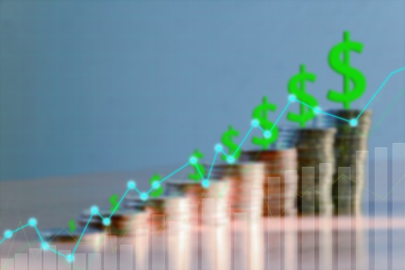 Rising stacks of coins with dollar signs on top.