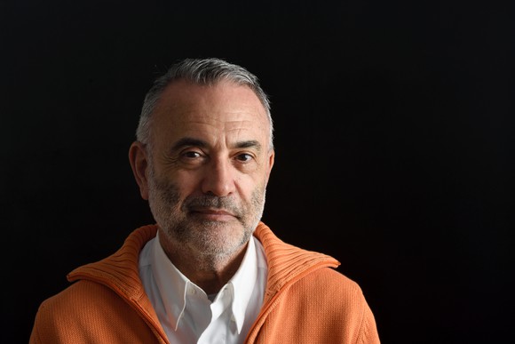 Serious older man against a black background