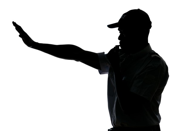 Traffic cop making stop gesture.