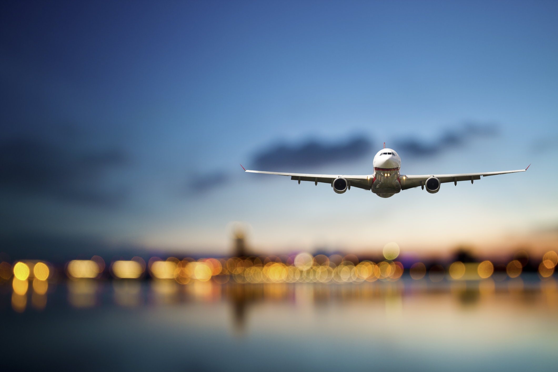 Commercial aircraft in flight with cityscape background