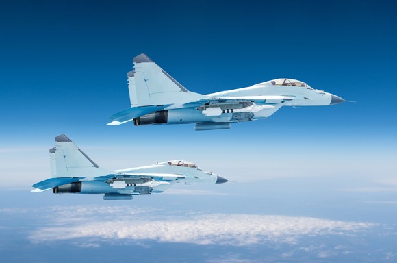Two military fighter jets at high altitude in the sky.