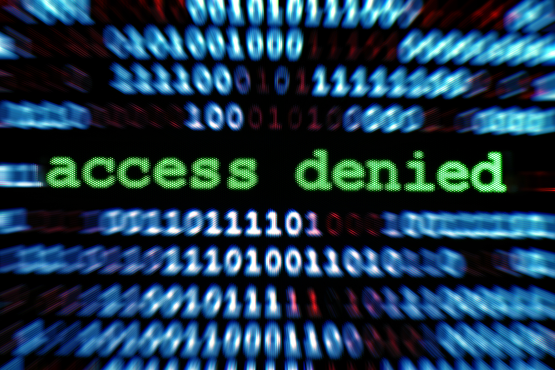 A digital screen that says access denied, surrounded by binary code.