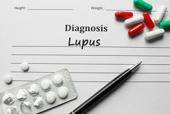 Form diagnosing lupus with medication and a pen