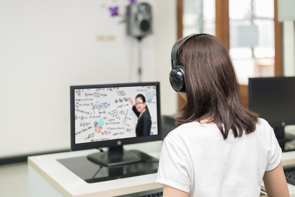 A woman takes an online class.