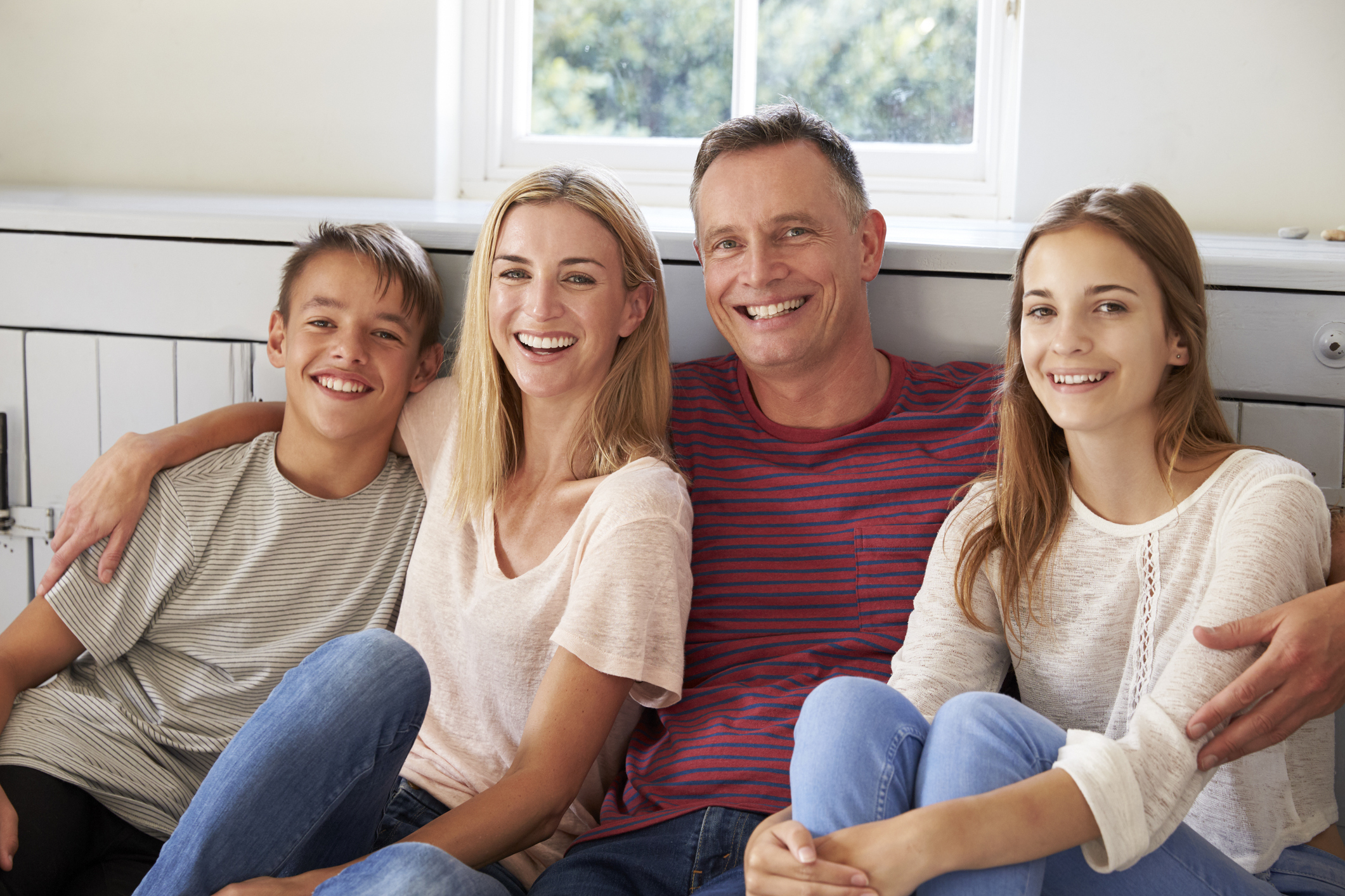 a nuclear family relaxing at home