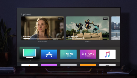 Large TV displaying TVOS interface, with the Apple TV sitting next to it