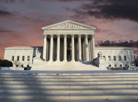 Supreme Court from street level, with view of steps leading up to the building, just before sunset.