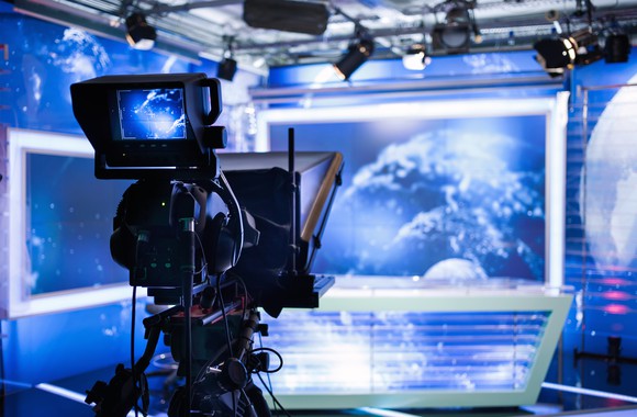 Interior of a television station studio desk and camera.