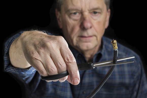 A man cuts a coaxial cable.