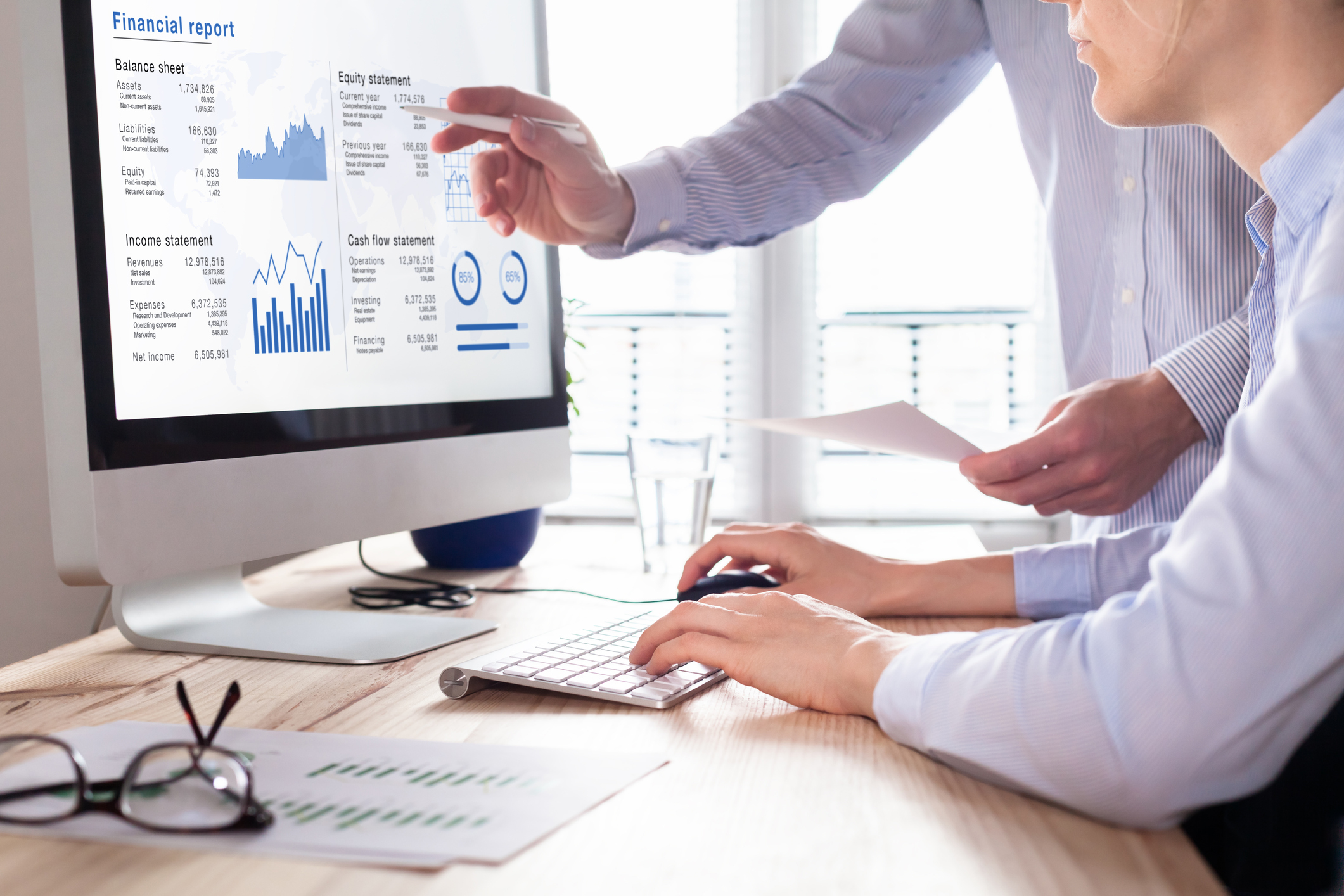 Two businessmen looking at accounting software