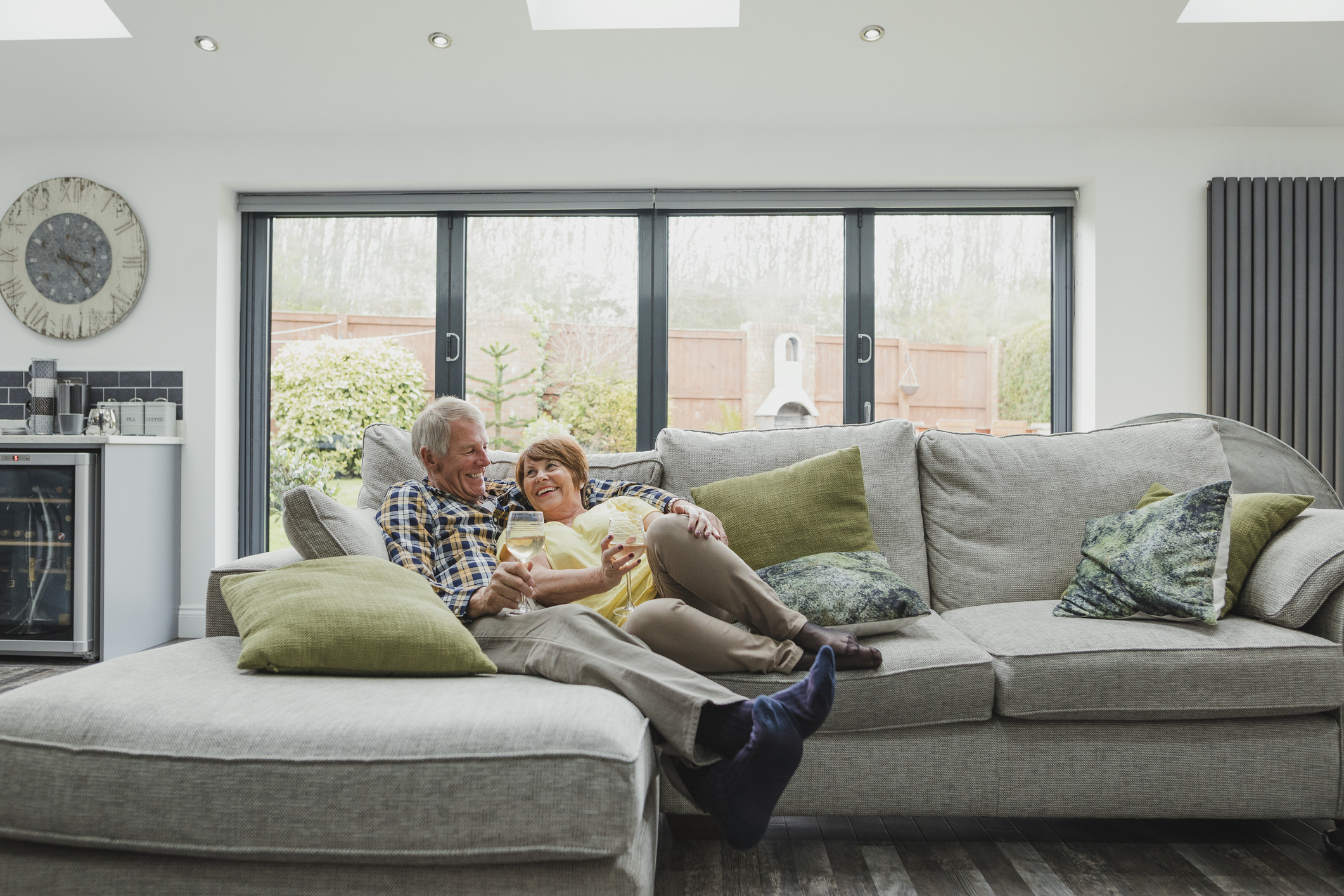Senior couple drinking wine on the couch