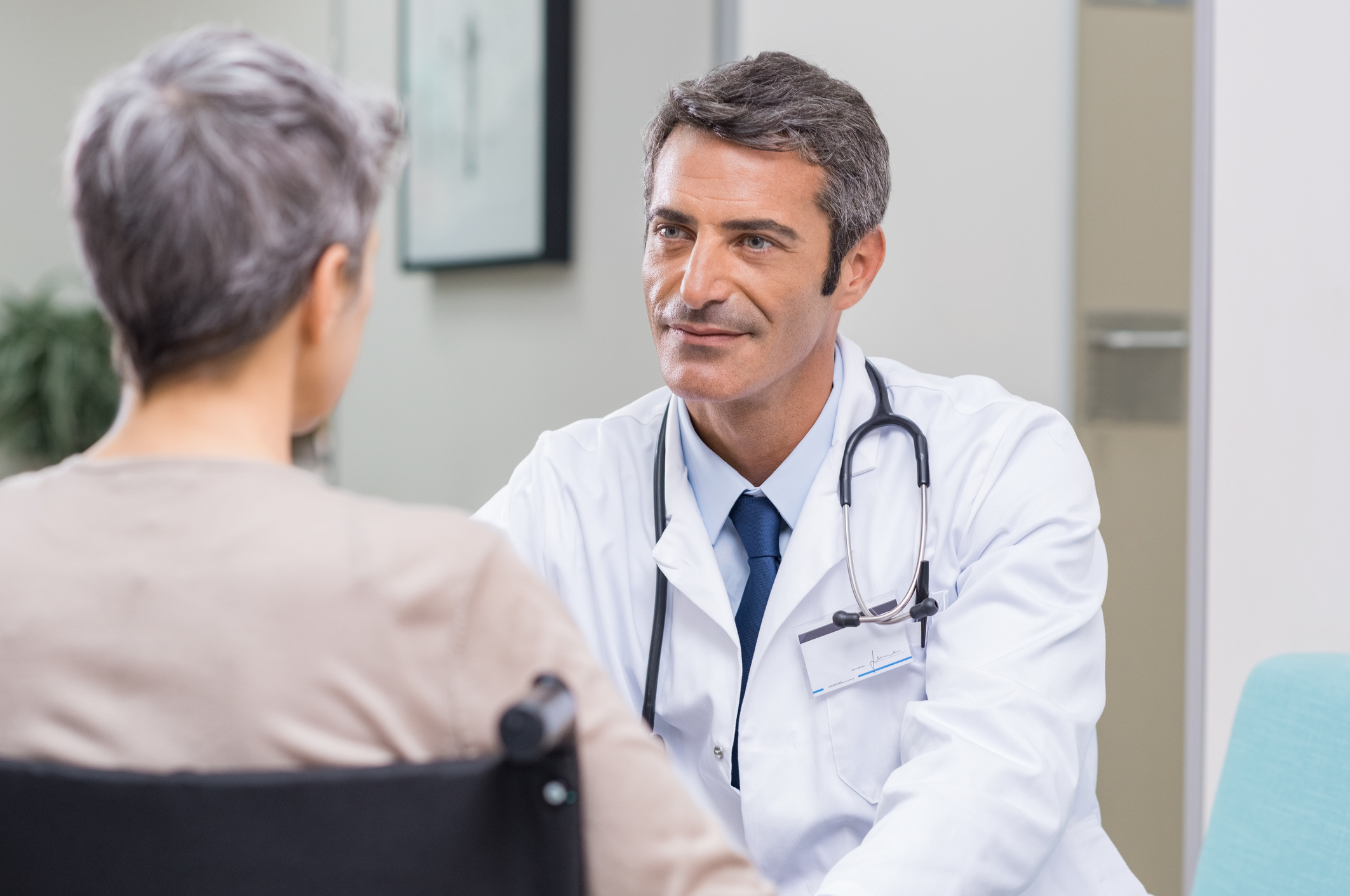 Doctor sitting across from older patient
