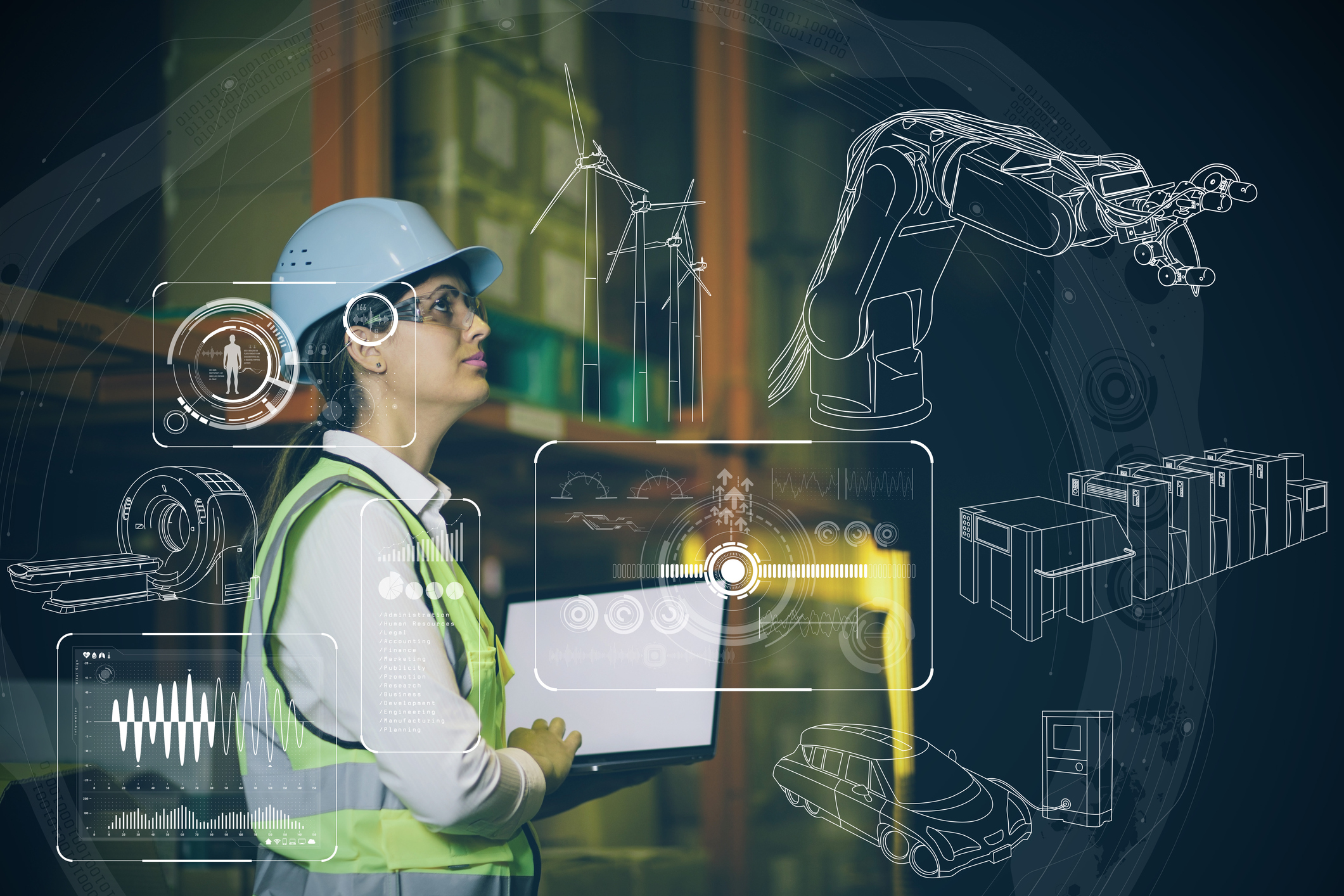 A worker uses a laptop to control an automated factory.