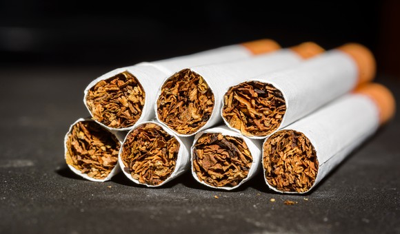 Seven cigarettes stacked on a table
