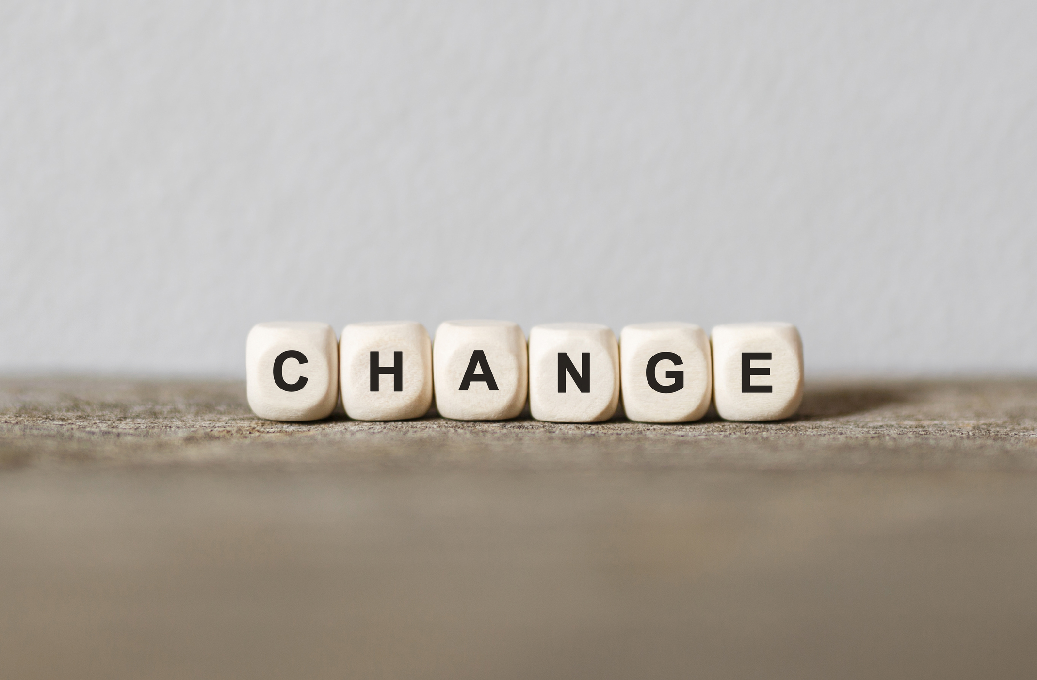 The word change spelled out in wood blocks.