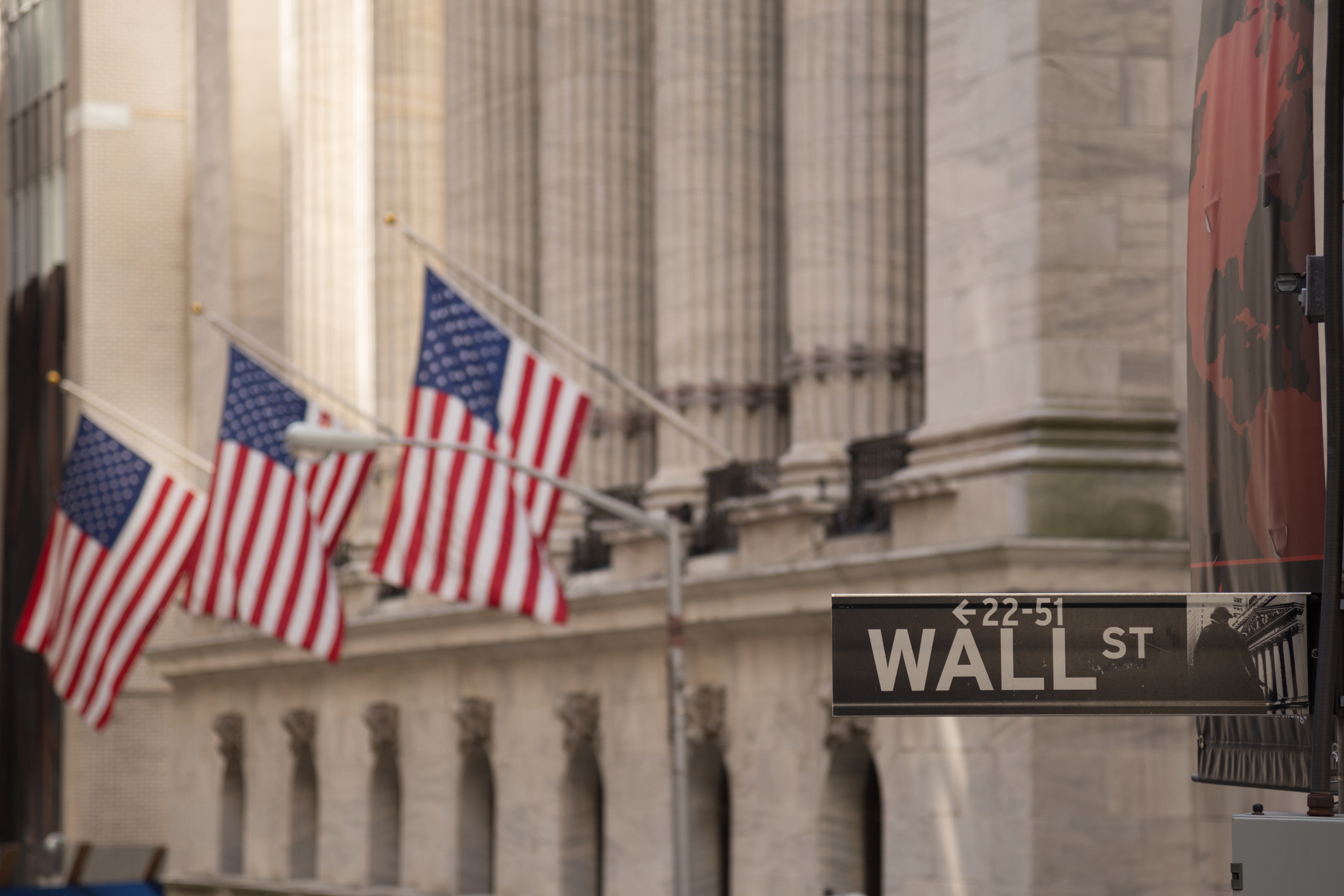 A "Wall Street" street sign in front of the stock exchange