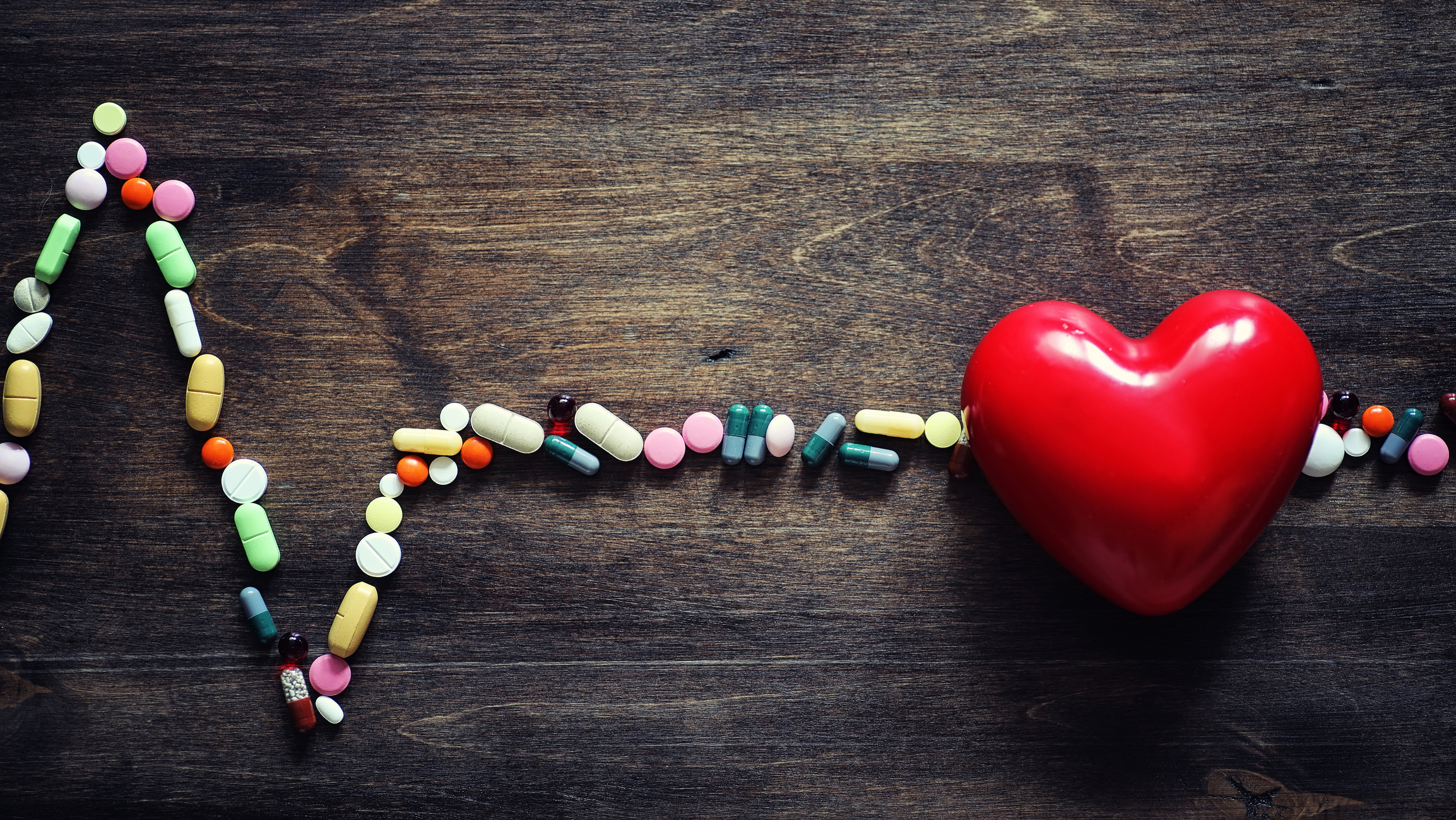 EKG made of pills with a big heart.