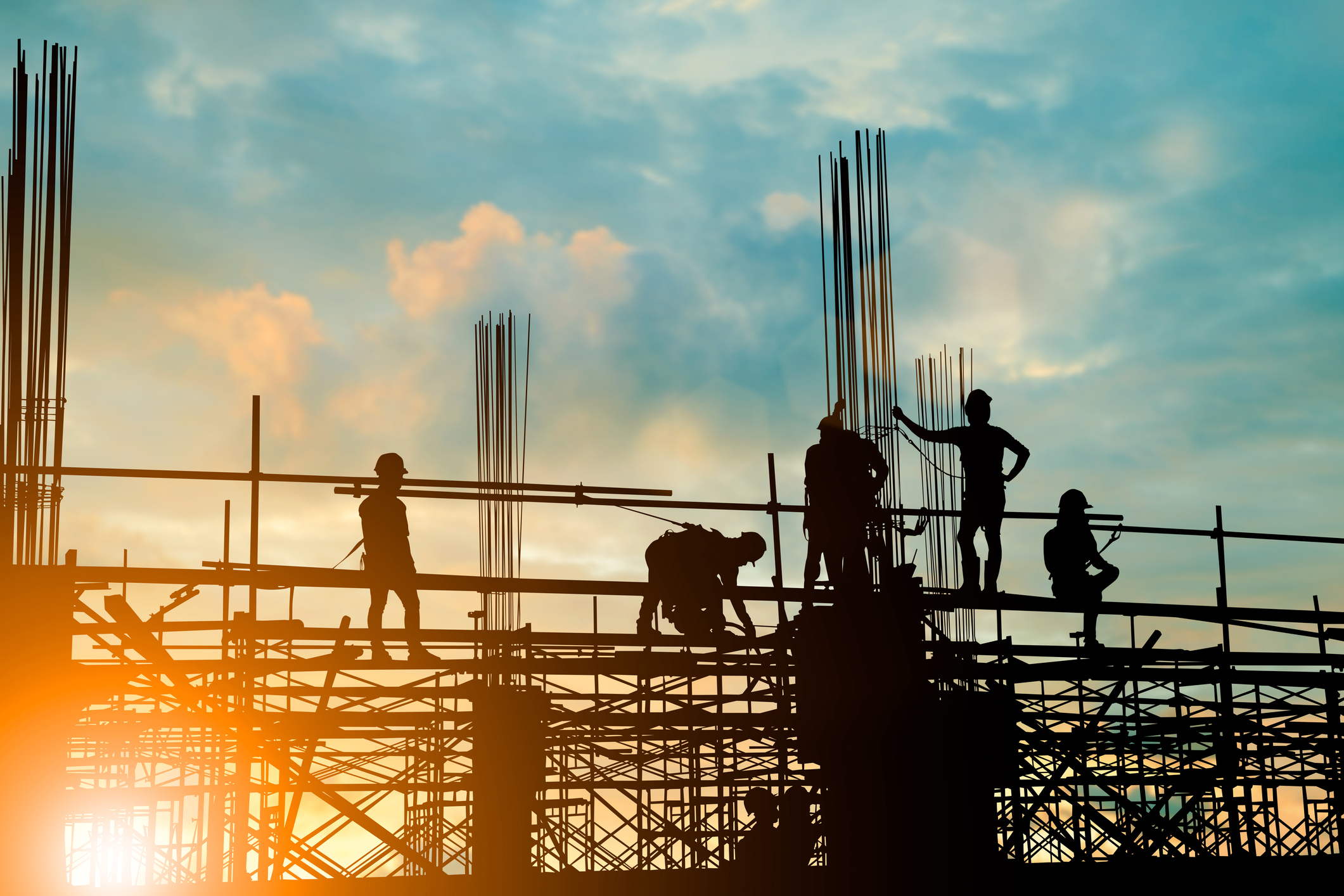 Silhouette of a construction team working on a project.