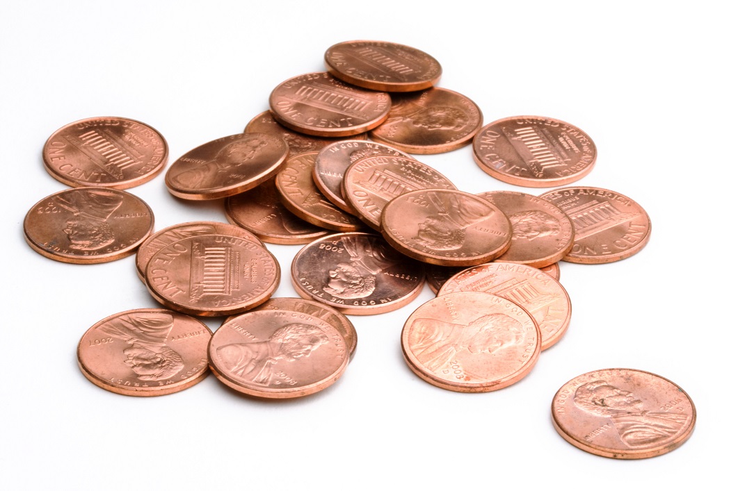 A group of U.S. pennies in a pile.