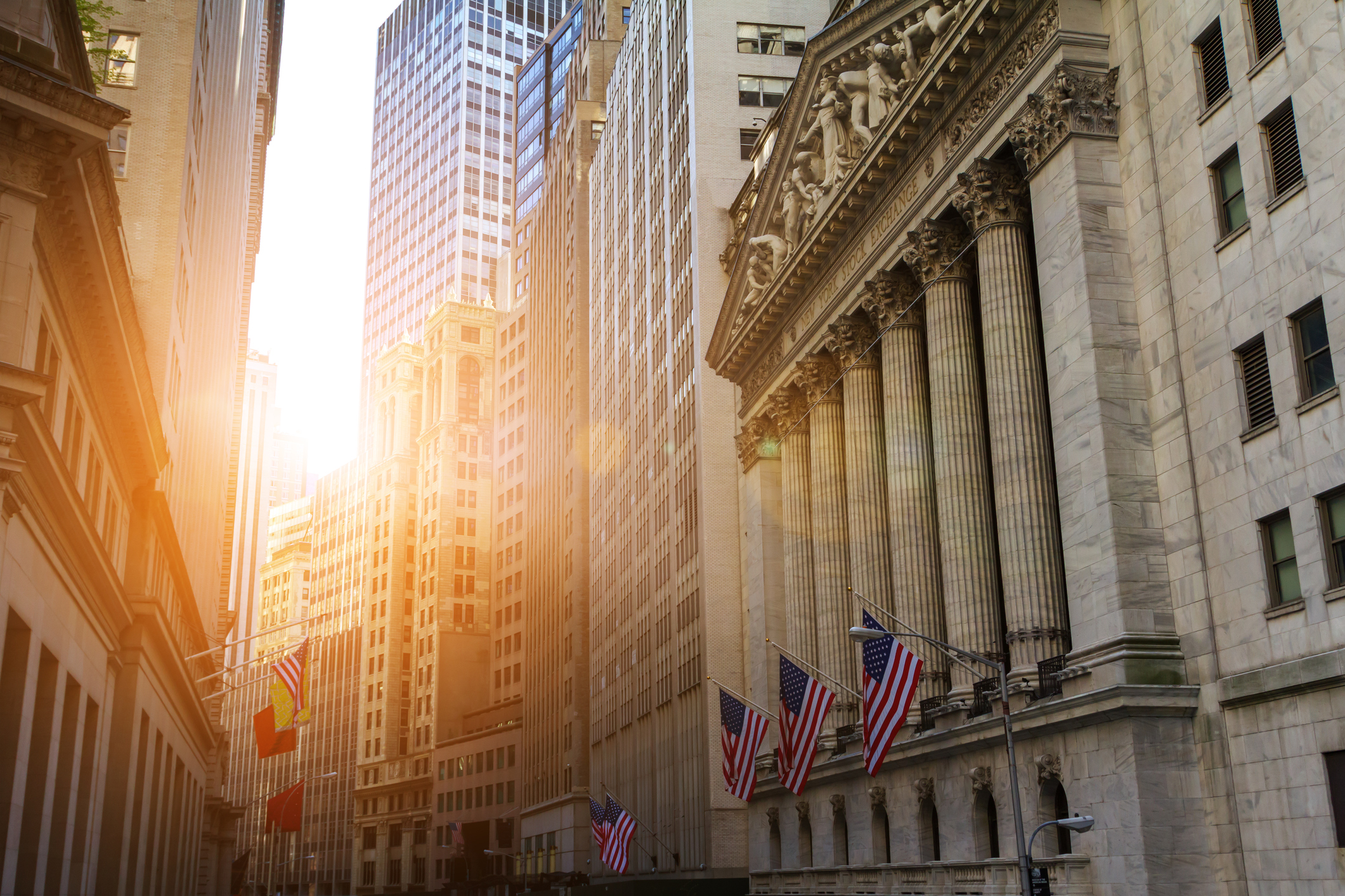 Sunlight shines on the historic buildings of the financial district in lower Manhattan, New York City near Wall Street