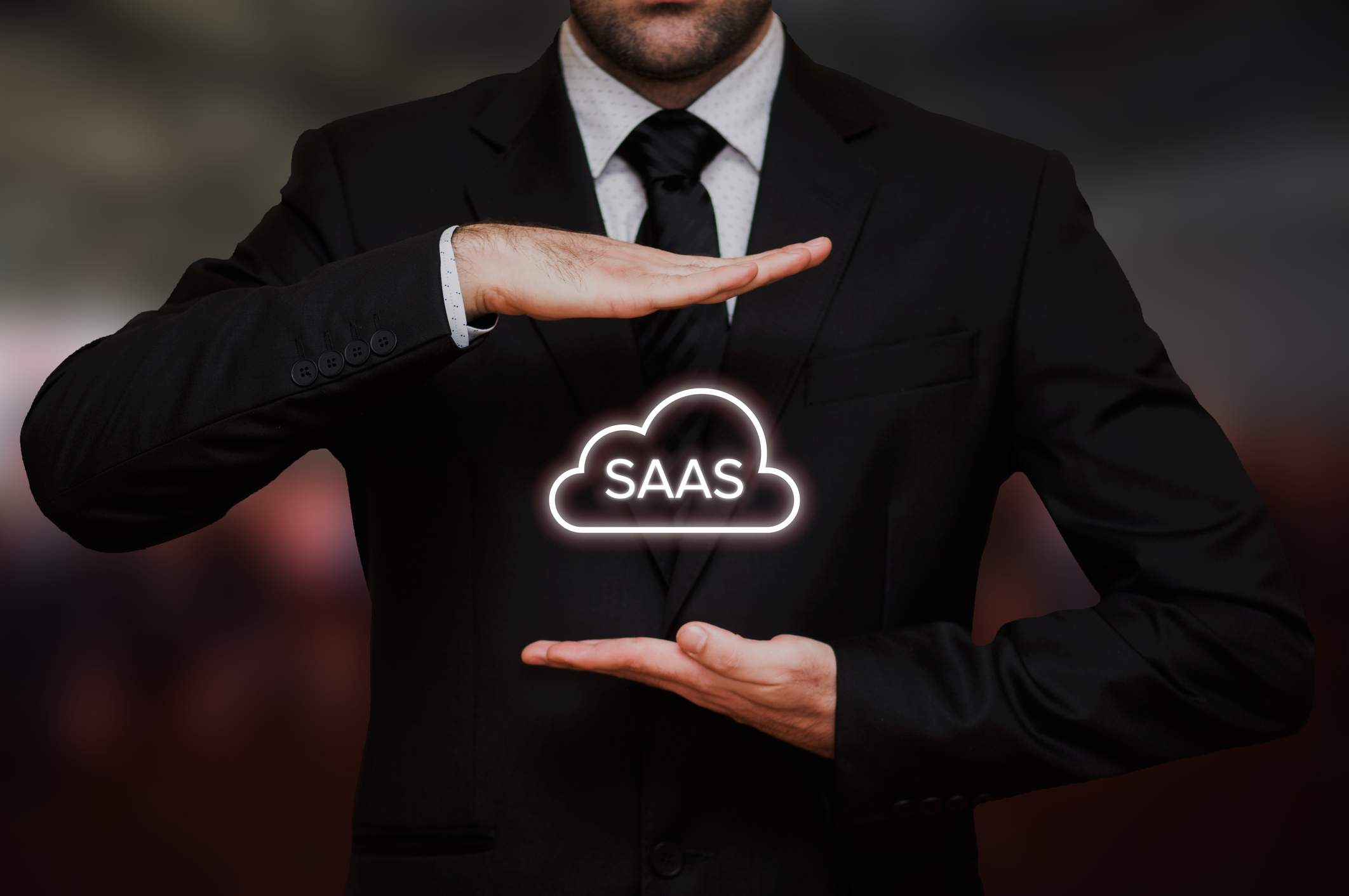 Software as a service concept text between hands of the businessman