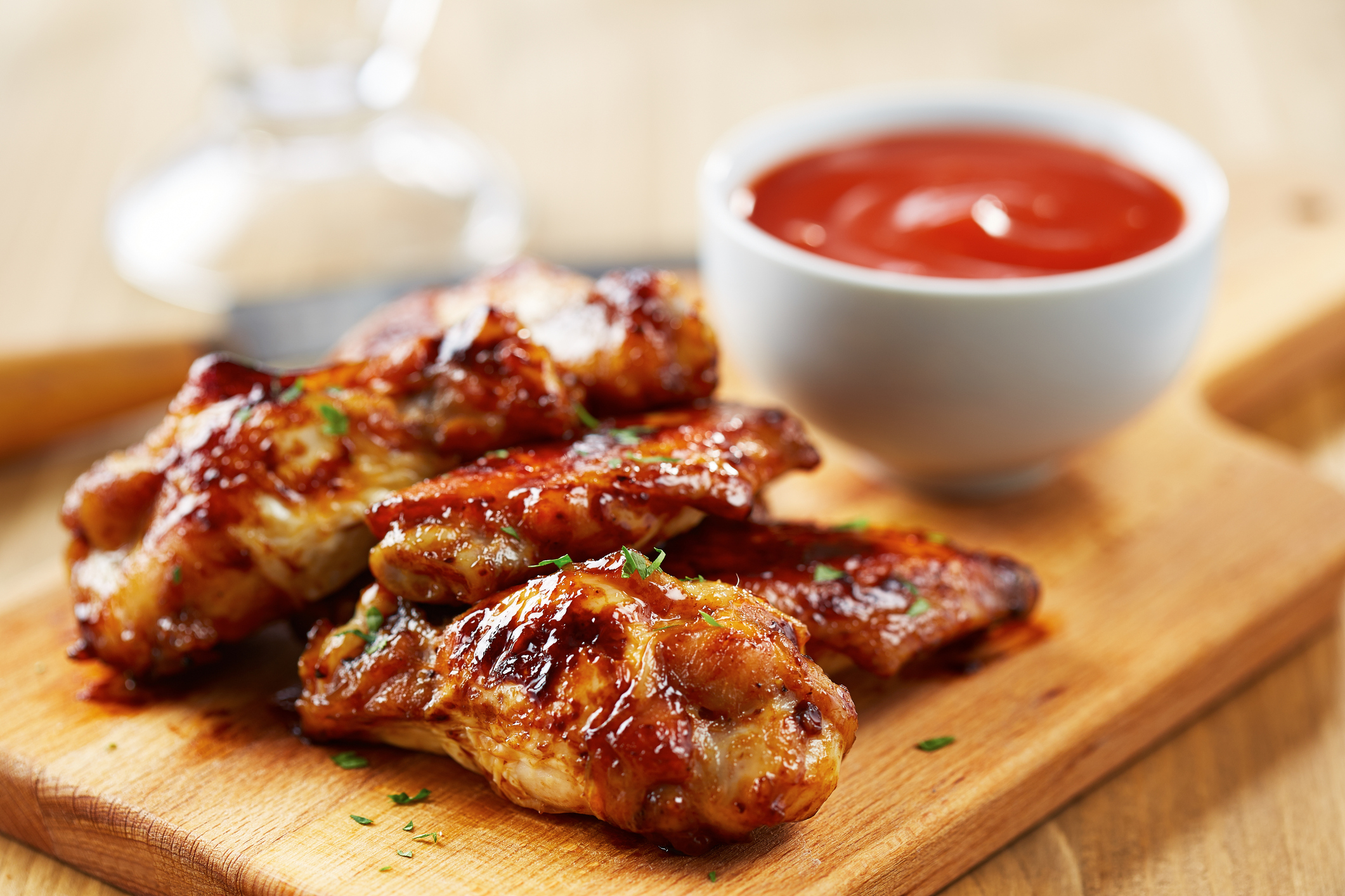 Chicken wings on a cutting board.