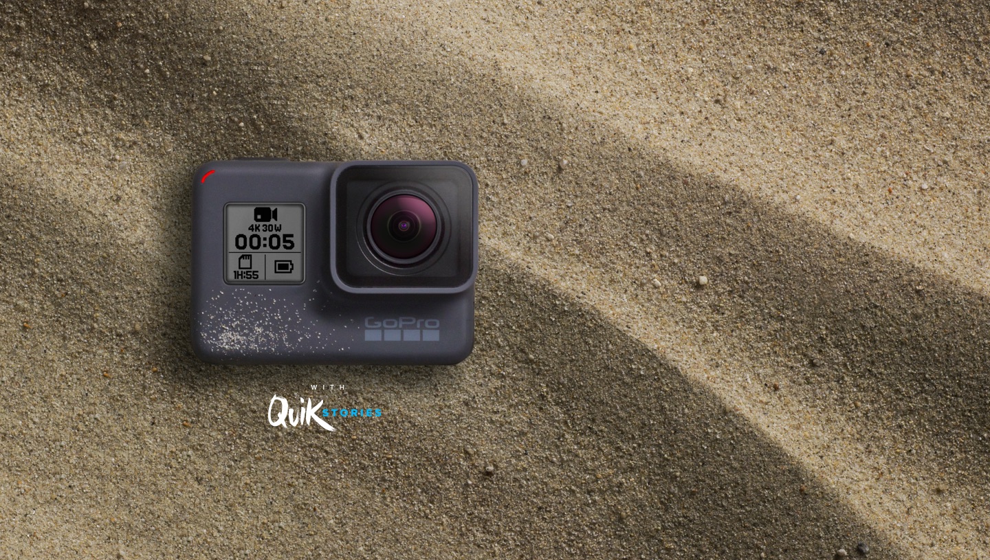GoPro Hero5 Black camera sitting in sand.
