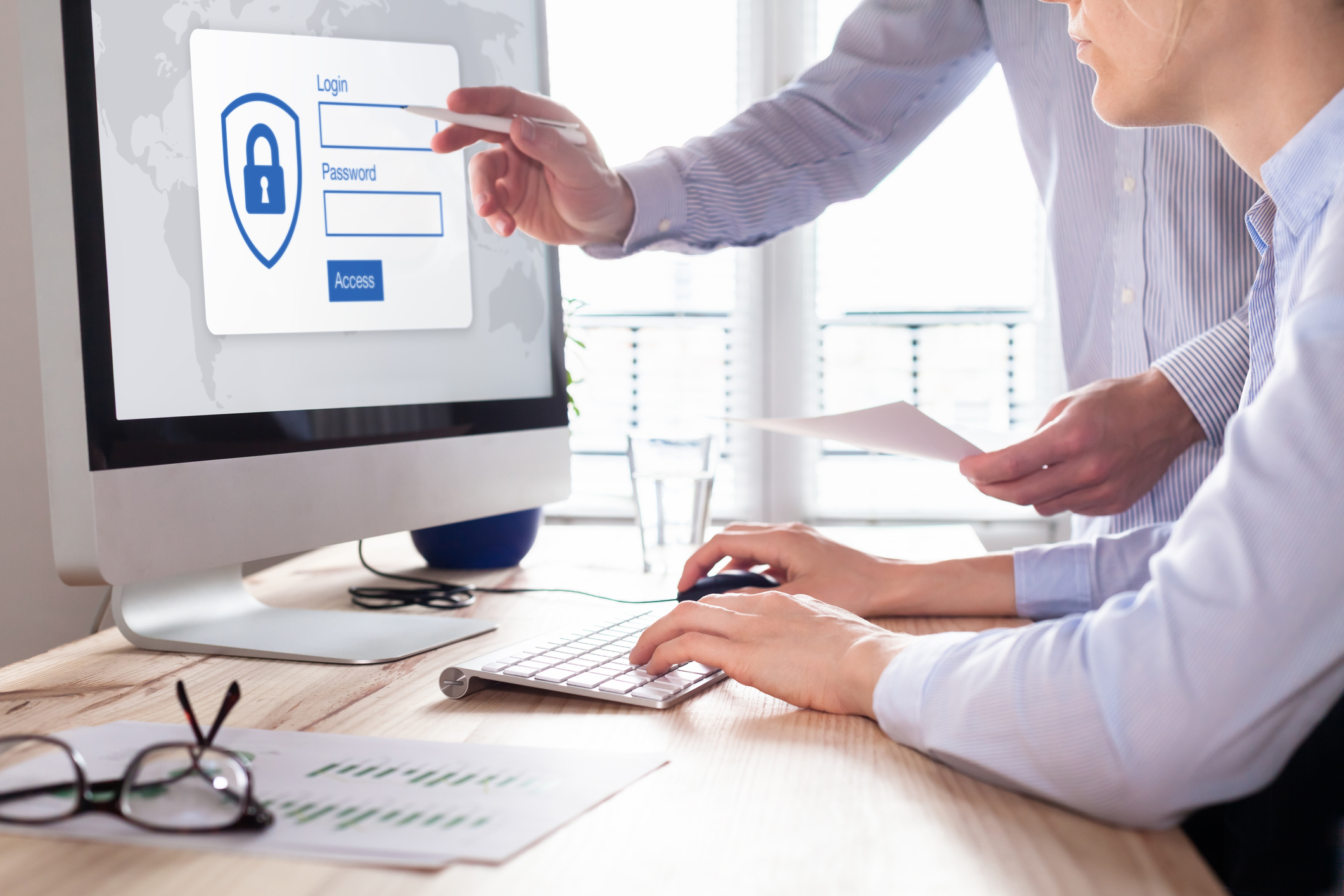 TWo business men looking at computer screen asking for login