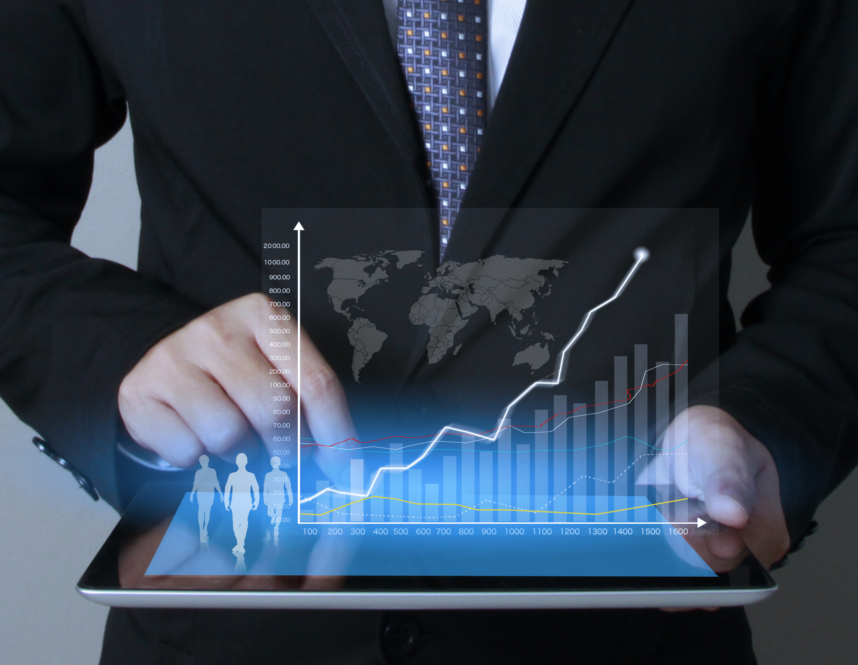 Businessman touching screen with chart coming off of it