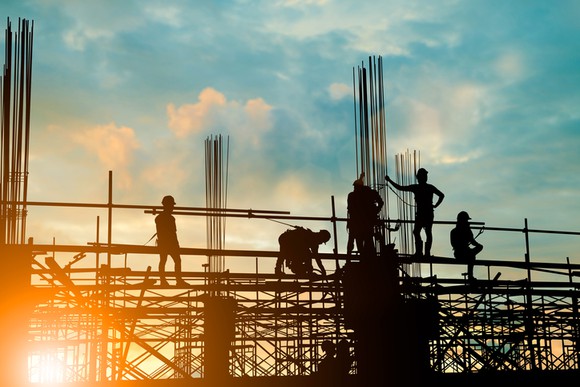Workers building a manufacturing facility.