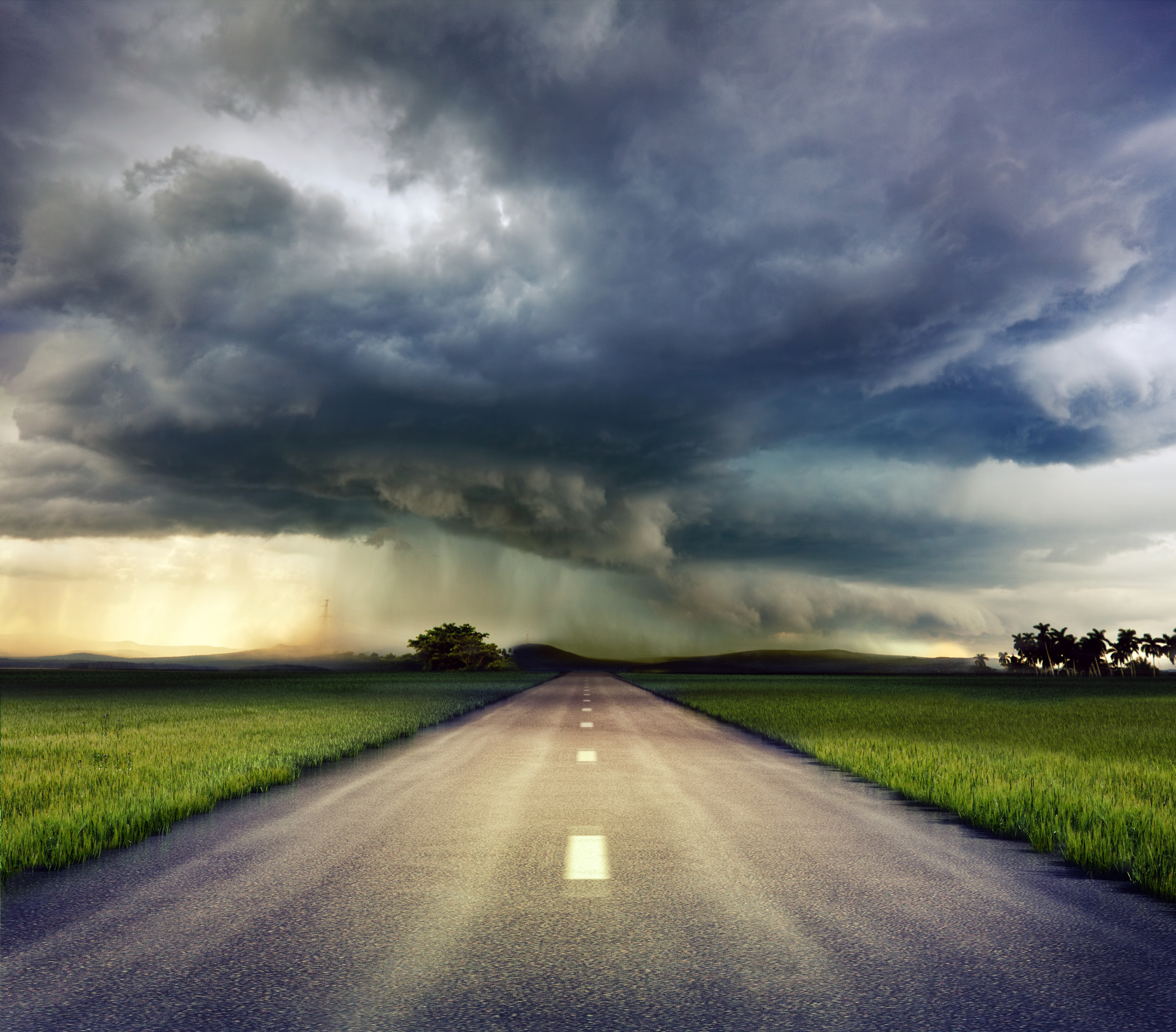 A storm on the horizon down a long road.