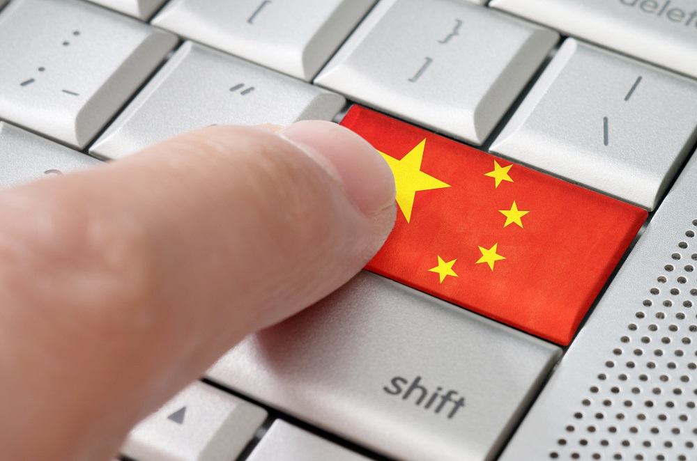 Computer keyboard with Chinese flag in place of enter key.