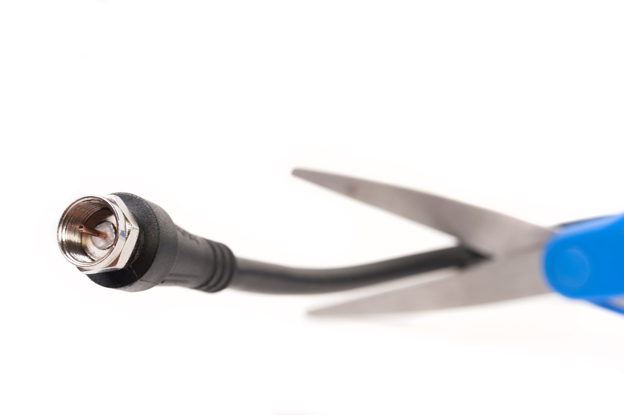 A cable cord being cut by scissors