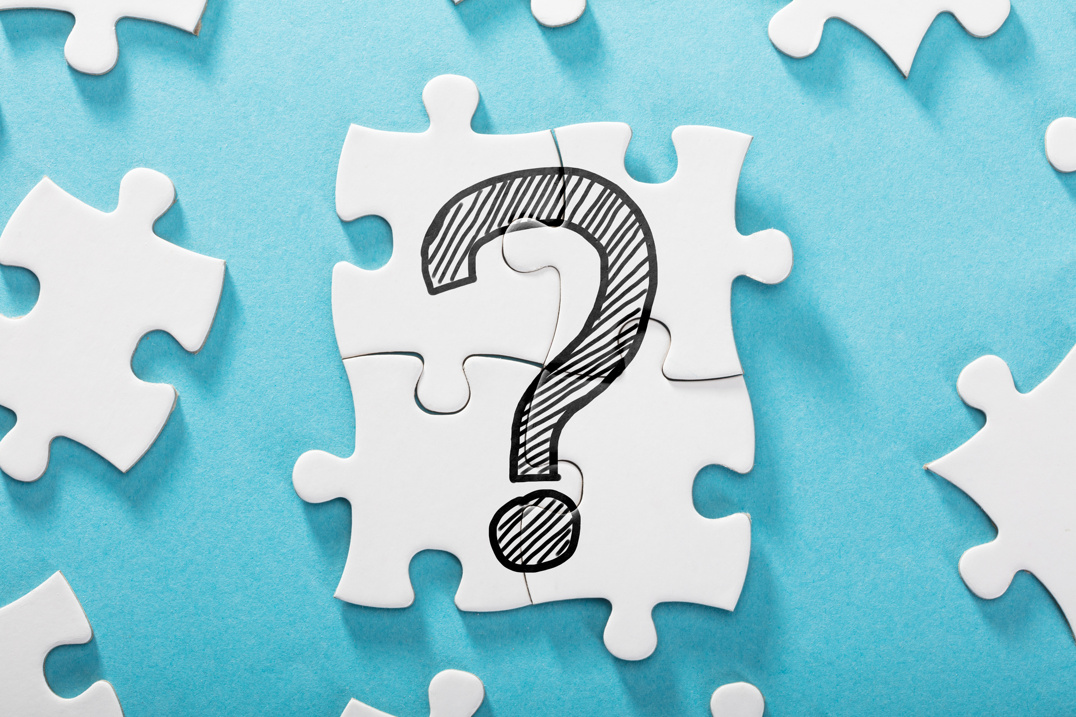 A question mark icon on several white puzzle pieces.