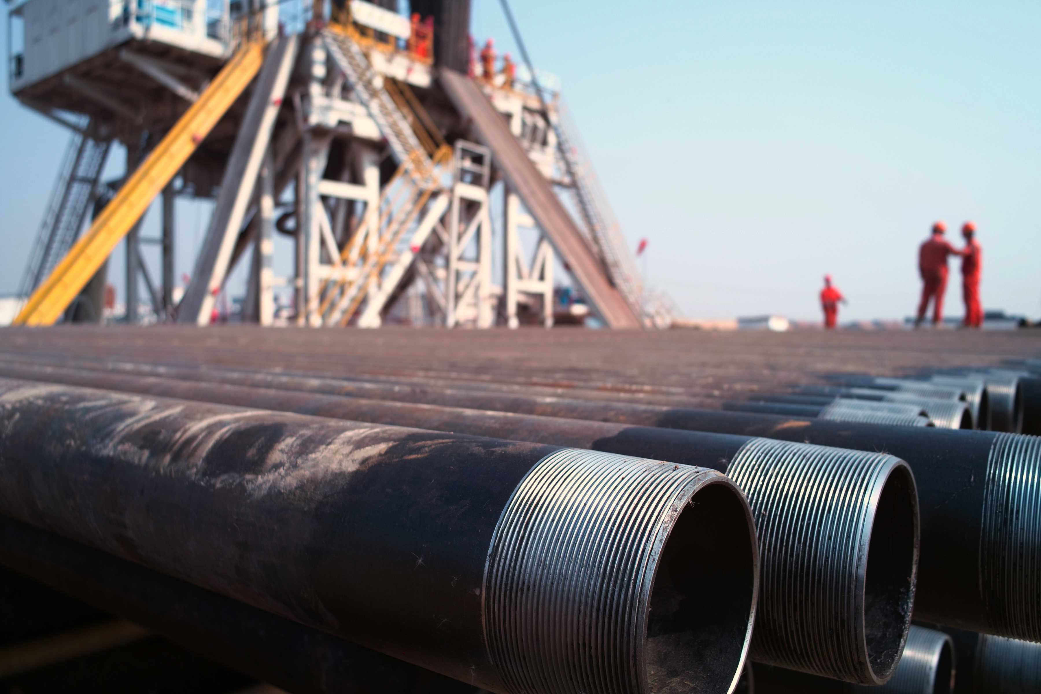 Drilling pipe next to a rig.