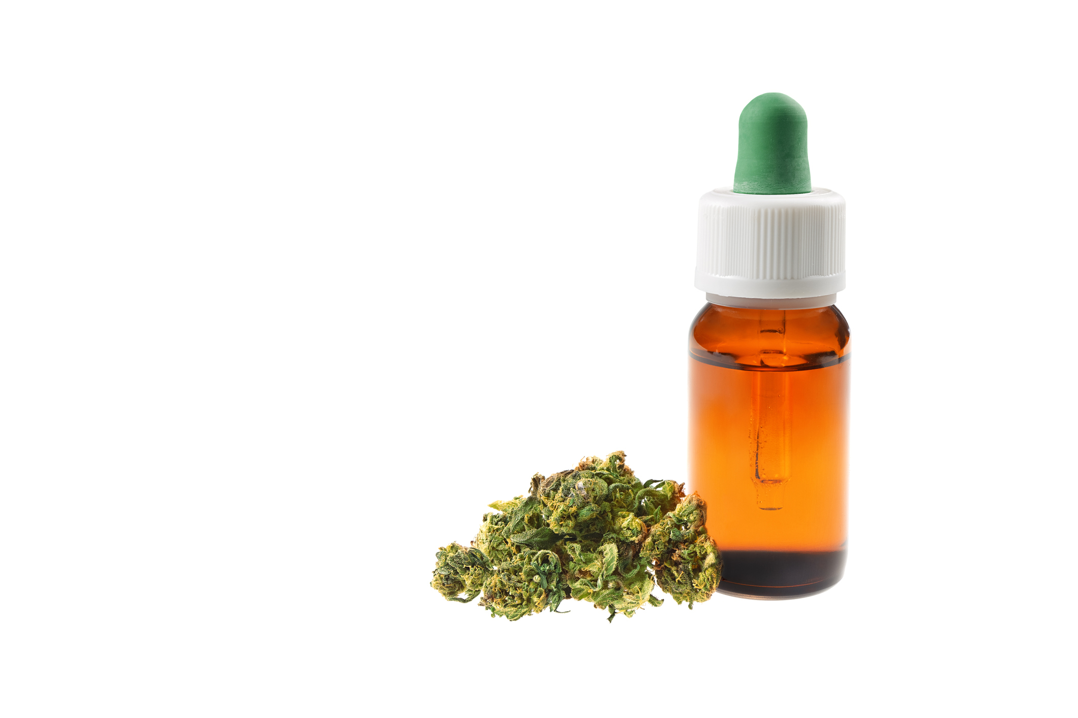 Marijuana buds next to CBD oil bottle