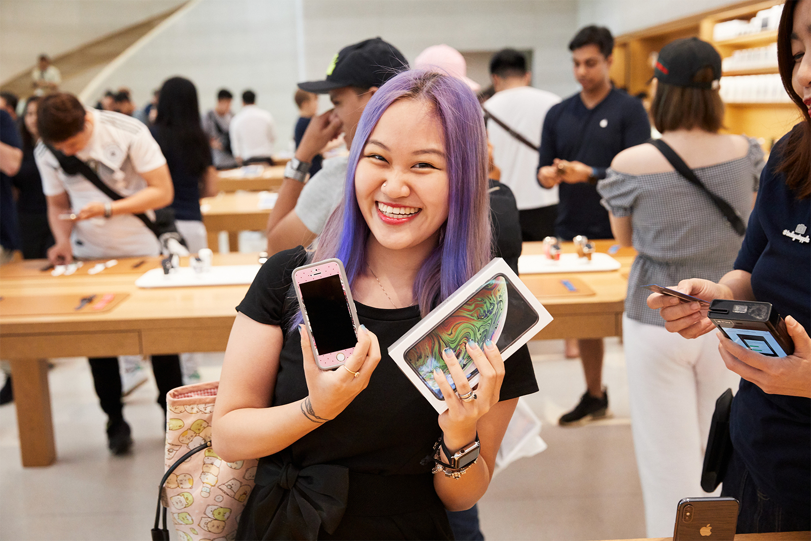 Woman holding up a new iPhone XS Max