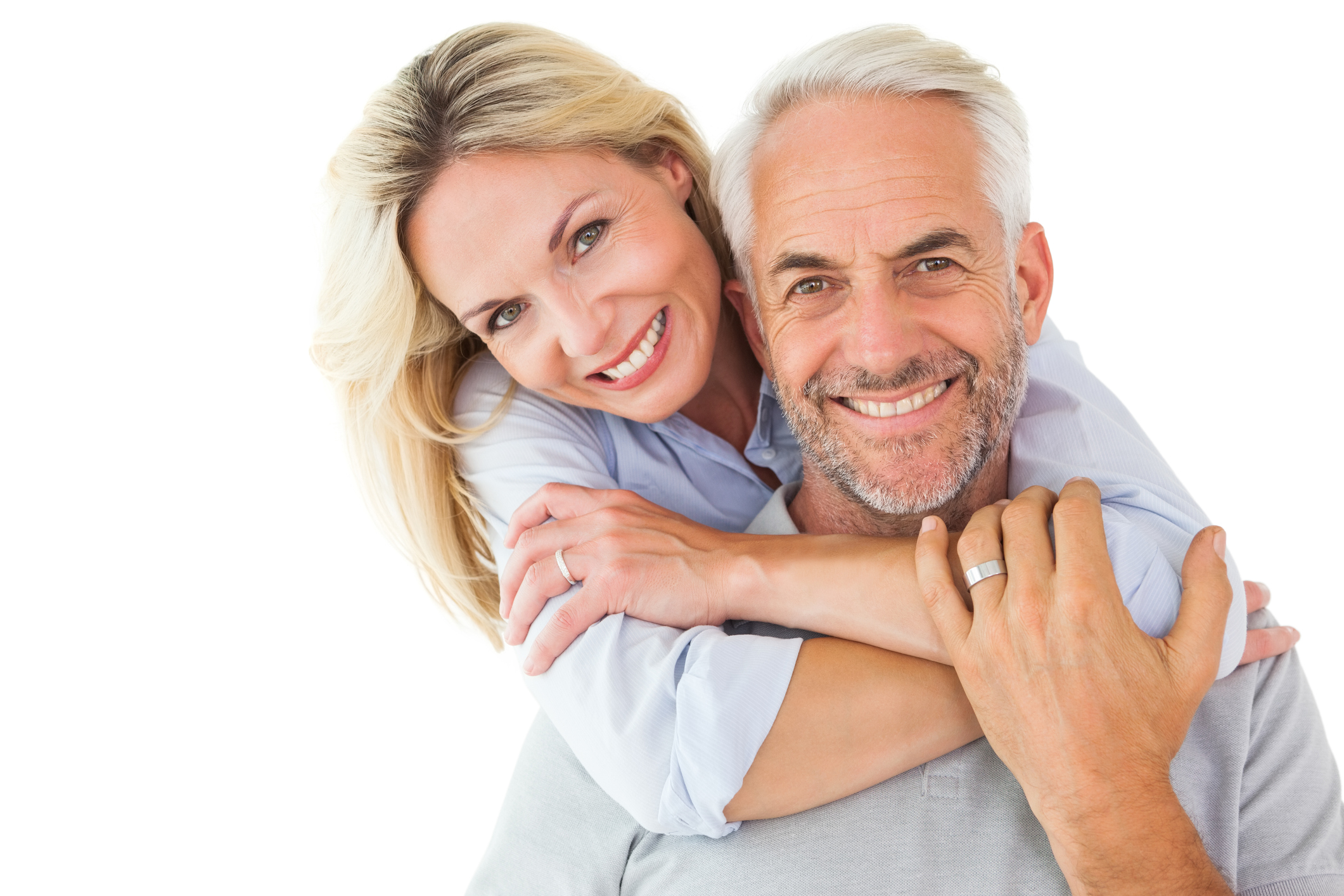Older couple smiling and embracing.