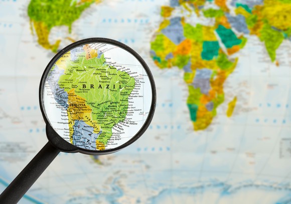 Magnifying glass over map of Brazil.