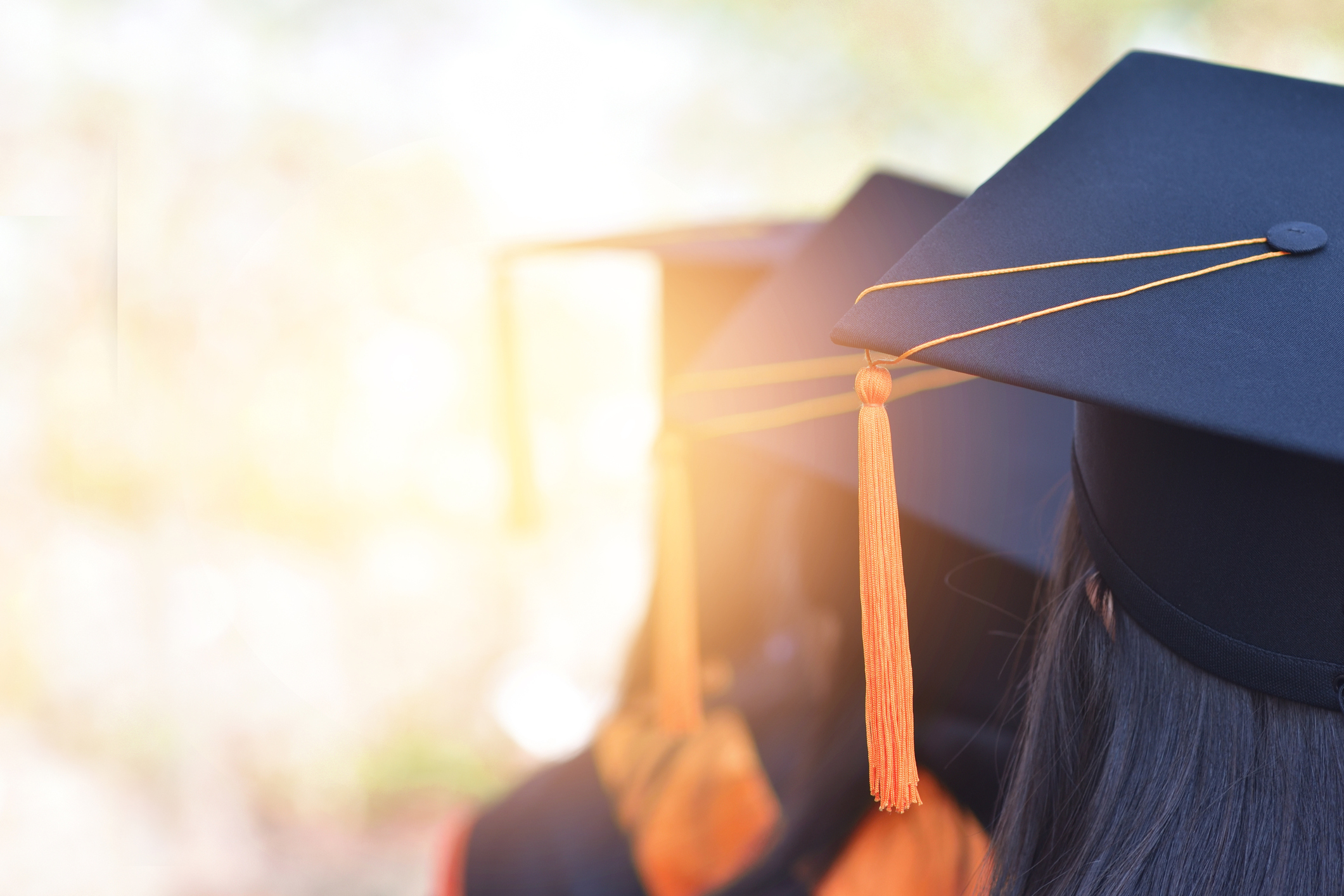 Graduates standing in line with their hats on.