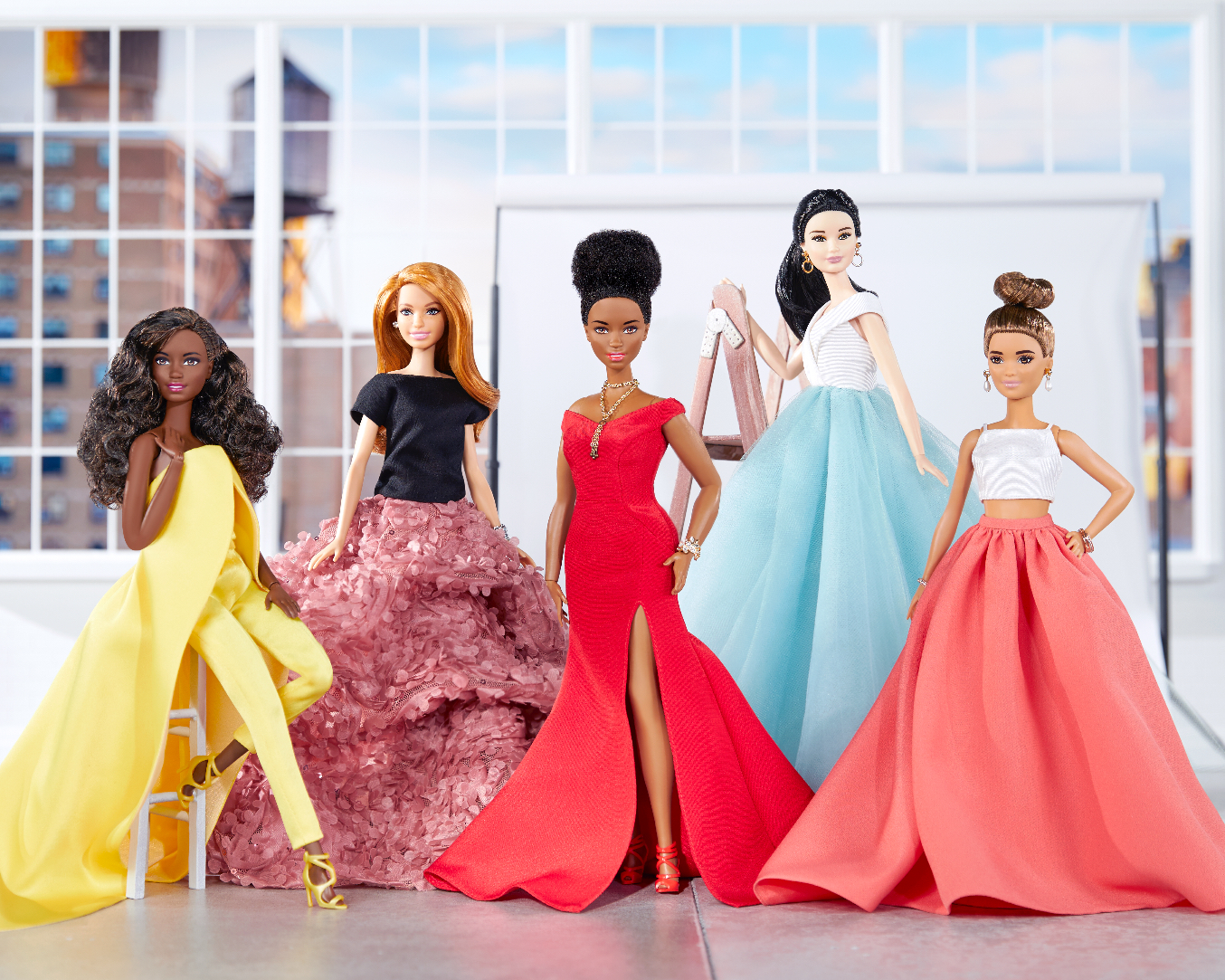 A variety of Barbie dolls dressed in outfits created by fashion designer Christian Siriano.