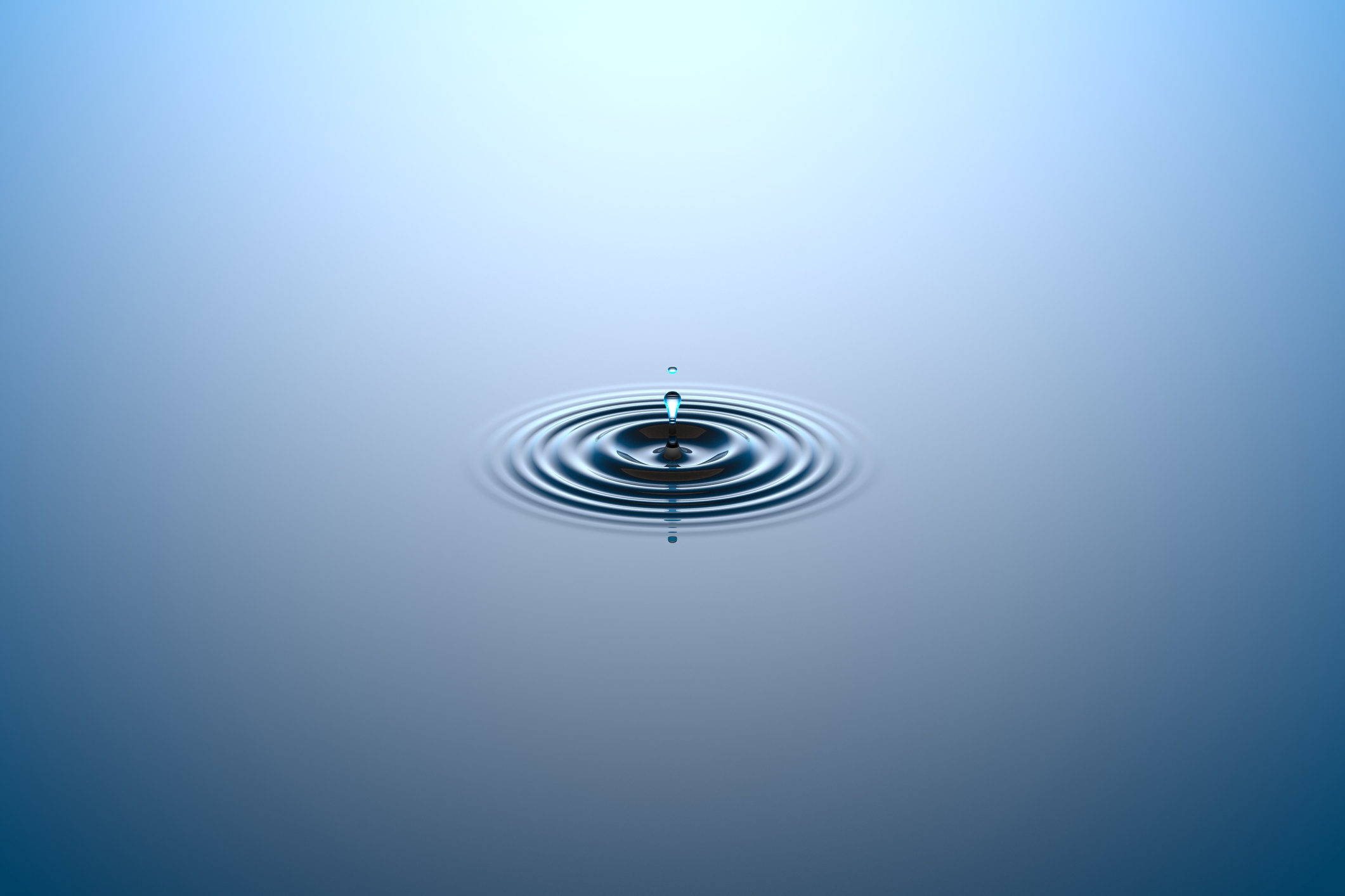 Water dropping onto a water surface.